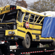 The bus being taken from the scene of the accident. Photo via AP